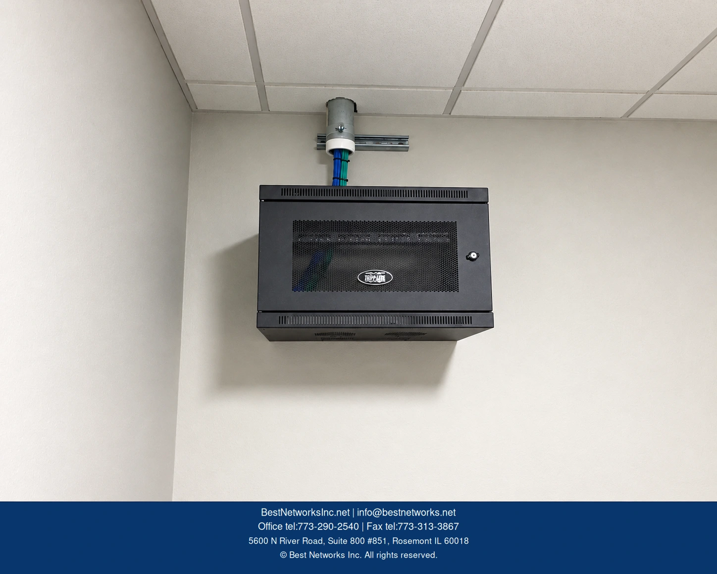 Wall-mounted business network cabinet and cable entry — enhanced version of supplied photograph